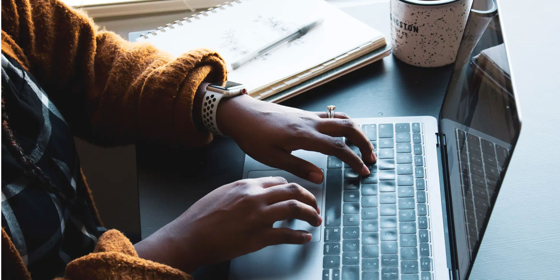 A person typing on a laptop