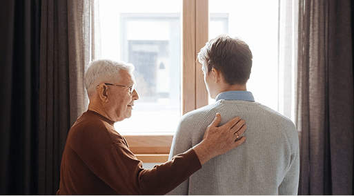 A grandfather consoling his grandson